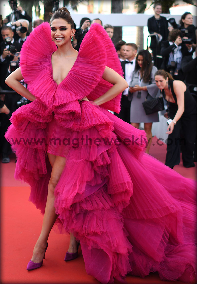 Deepika Padukone in a hot pink origami gown from Ashi Studio. The actress finished her look with matching heels by Aquazzura, emerald jewellery from Lorraine Schwartz, bold smokey make-up and a textured high bun.